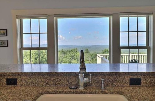 Center Ossipee House | Sunset Slopes: A spacious 4-bedroom home in scenic Wilmot, NH, with garden views.