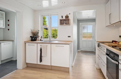 Vemmelev House | Surrounded by green meadows and fields, this inviting vacation home in Westseeland welcomes you.