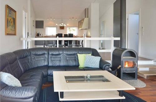 Lyngsbæk Strand House | The cottage is beautifully placed on a large fenced natural ground, where lawn has been laid.