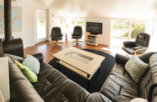 Lyngsbæk Strand House | The cottage is beautifully placed on a large fenced natural ground, where lawn has been laid.