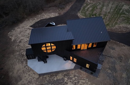 Janesville Cabin | The Overhang · Luxury River Retreat with Sauna, Hot Tub, Movie Theater, & Arcade