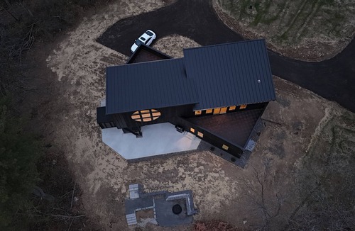 Janesville Cabin | The Overhang · Luxury River Retreat with Sauna, Hot Tub, Movie Theater, & Arcade