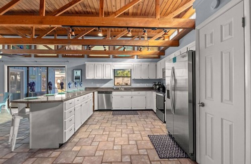 Thomas Drive House | The Tiki Hut ~ Tropical Retreat with Pool, Tiki Bar, Game Room & Dog-Friendly Vibes