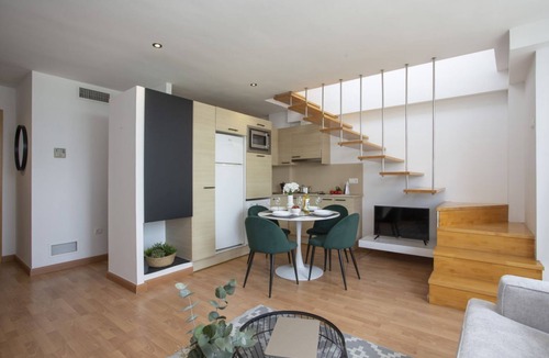 Castello de la Plana Apartment | This charming duplex penthouse for 4 people is the perfect combination of spaciousness, light, and comfort. On the lower floor, you'll find a cozy studio with a 150 cm double bed in the sleeping area, partially separated from the living room by a wall fo