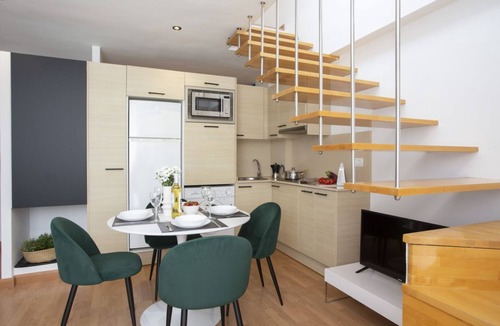 Castello de la Plana Apartment | This charming duplex penthouse for 4 people is the perfect combination of spaciousness, light, and comfort. On the lower floor, you'll find a cozy studio with a 150 cm double bed in the sleeping area, partially separated from the living room by a wall fo