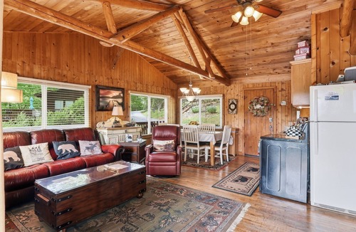 Huddleston Cabin | This cozy 2-bedroom, 1-bath retreat is wrapped in warm cedar with soaring cathedral ceilings, creating the perfect blend of rustic charm. Enjoy beautiful gardens and breathtaking views of the lake and mountain.
