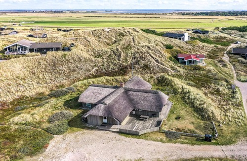 Houvig Strand House | This cozy cottage is located under a romantic thatched roof.