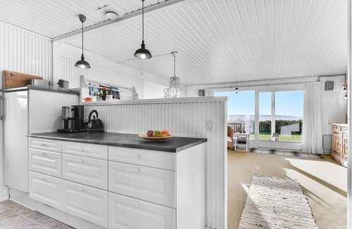 Ebberup House | This cozy cottage with a panoramic view of the sea is located just a few steps from the water.