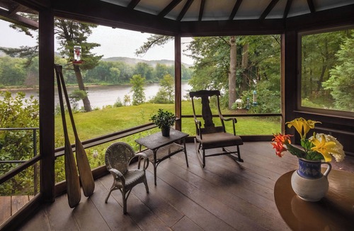 Scandia House | This historic 1911 summer cabin set along the saint croix river offers a quiet step back in time. Filled with original character, the home features a cozy fireplace, screened porches with sweeping river views. Simple, serene and surrounded by nature.