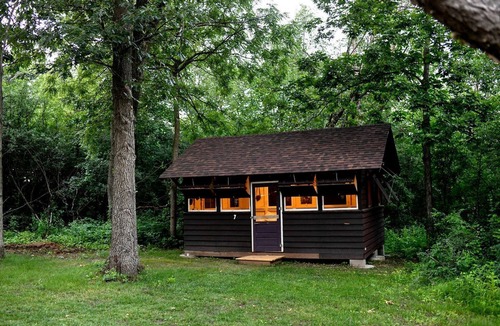 East Troy Cabin | Three Cozy Historic Scout Cabins with Fire Pit, BBQ, and Hammocks for a Memorable Family Adventure in Troy, Wisconsin