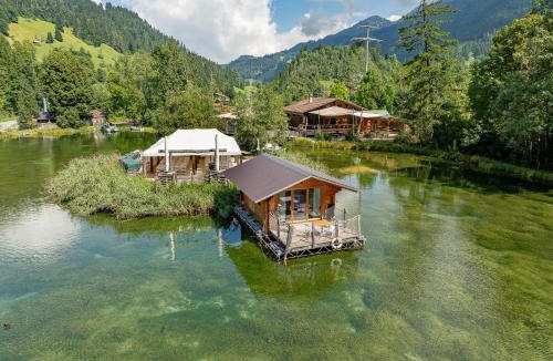 Zweisimmen House | Tiny Water Villa on a Lake with shared camping bathroom