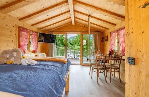 Zweisimmen House | Tiny Water Villa on a Lake with shared camping bathroom