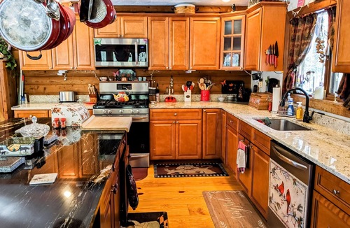 Raymond House | Tranquility, stone fireplace, lofted ceilings, wall of windows, & views