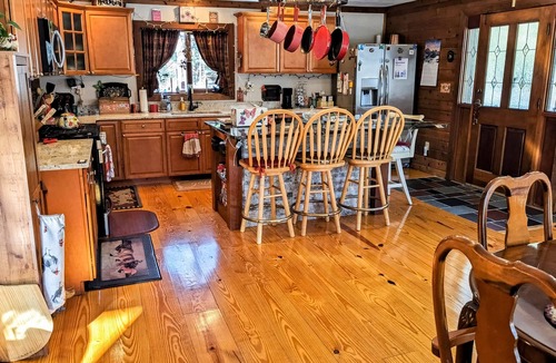 Raymond House | Tranquility, stone fireplace, lofted ceilings, wall of windows, & views