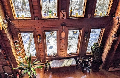 Raymond House | Tranquility, stone fireplace, lofted ceilings, wall of windows, & views