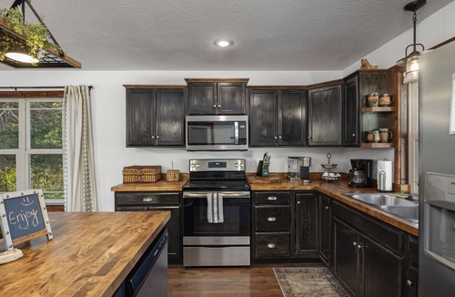Turners Cabin | Unique,modern, secluded cabin on 95 river front acres-utv-kayaks-trails-hot tub