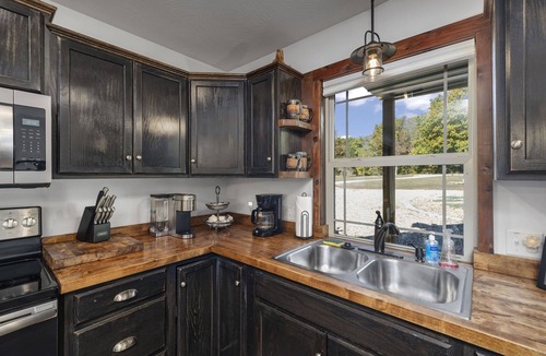Turners Cabin | Unique,modern, secluded cabin on 95 river front acres-utv-kayaks-trails-hot tub