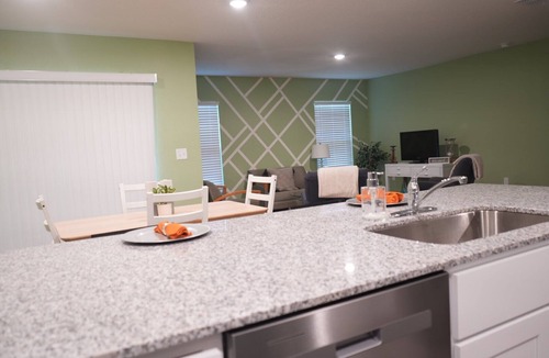 Poinciana House | Unwind in this serene thoughtfully designed home nestled in a quiet neighborhood