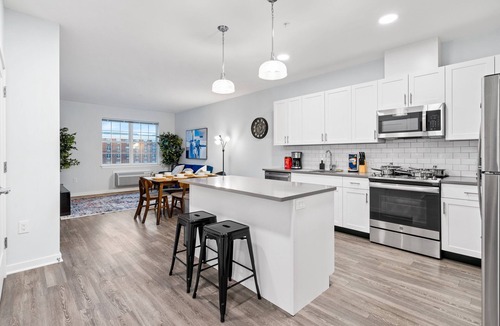 Hackensack River Waterfront Condo | Urban Elegance: 20 Minutes to NYC with Luxe Amenities- Gym and Laundry In Unit