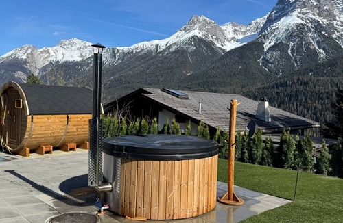 Engadin Scoul House | Vacation home with wellness area in alpine chic retro style