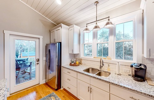 Tranquil Harbour House | Vibrant beach-themed stay with balconies, enclosed yard, extra kitchenette, & AC