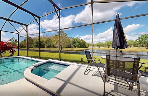 Trafalgar Village House | Water view retreat with lanai, heated pool, pool spa, game room, & AC