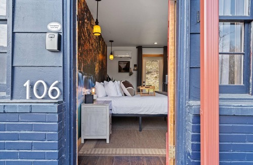 Hancock Hotel | Waterfall Retreat | Serene Room with Forest Mural at Green Acres Retreat