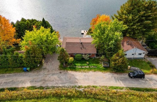 Saint-Andre-Avellin House | Waterfront Cottage with Hot Tub and Waterfalls