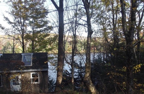 Grantham Cottage | Waterfront Camp looking down on water from deck.