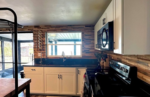 Lake Panasoffkee House | Waterfront Oasis, private dock, cozy fire pit, jacuzzi, stunning views & more