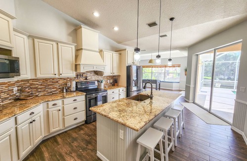 Palm Harbor House | Waterfront Pool Home | Dock | Game Room | King Bed