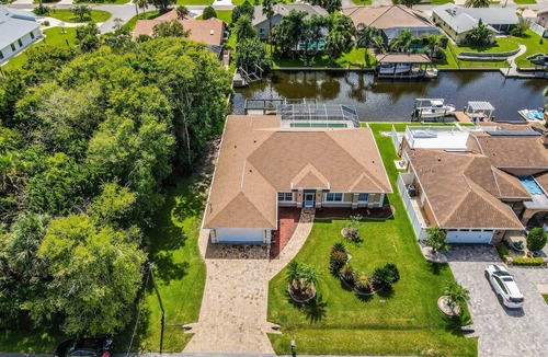 Palm Harbor House | Waterfront Pool Home | Dock | Game Room | King Bed