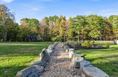 Brackney Cabin | Waterfront Tiny House Perched on the Pond Covered Deck at Water’s Edge