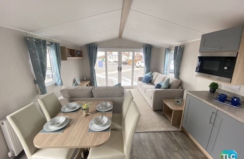Dunbar House | Well appointed caravan with patio doors and decking.