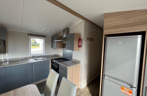 Dunbar House | Well appointed caravan with patio doors and decking.