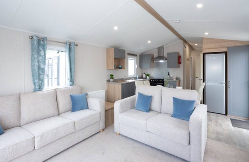 Dunbar House | Well appointed caravan with patio doors and decking.