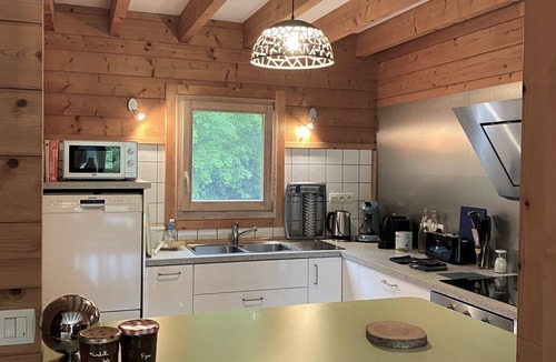 Baudement Ski Chalet | Wooden House in a green setting.