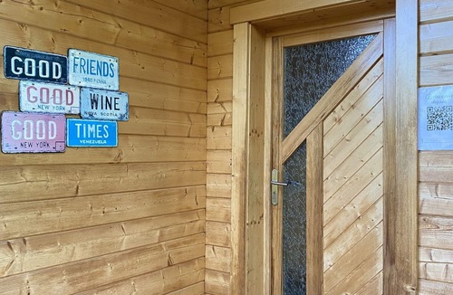 Baudement Ski Chalet | Wooden House in a green setting.