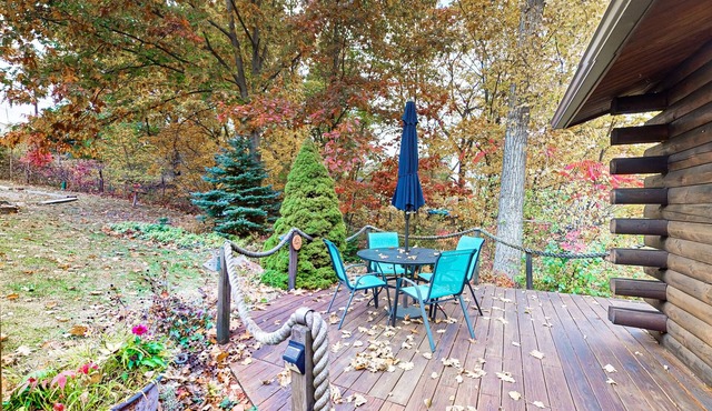 1-acre lakefront log cabin with dock, 50 ft water frontage, hot tub, & deck