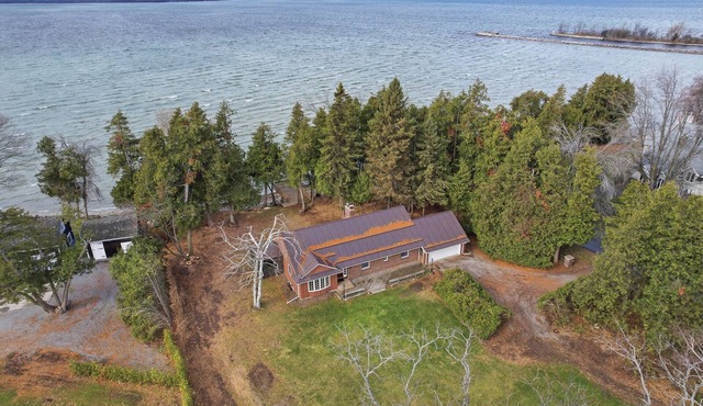 1-acre private waterfront cottage on Lake Simcoe featuring 150' of sandy beach