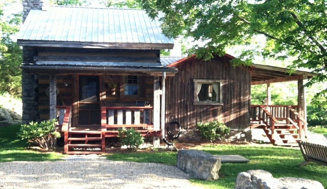 1800’s restored log cabin on 26 private rolling wooded acres with sunset views