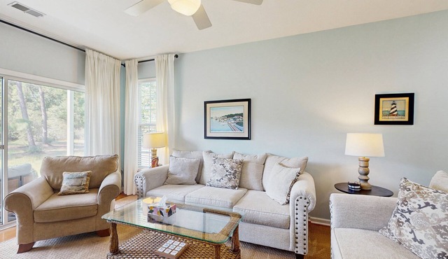 1st-floor corner condo with water view, on-site pool, & screened patio