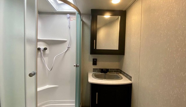 2 separate RV’s with queen-sized beds, dining area, and full kitchen.