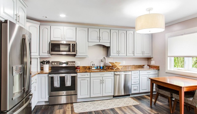 2-story, riverfront home with private dock, inviting deck & dog-friendly yard