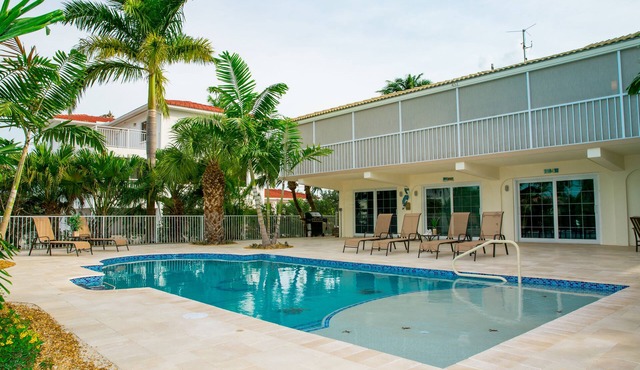 4 bedroom/3 bathroom on Canal w/HEATED POOL and New Outdoor kitchen w/Bar Area