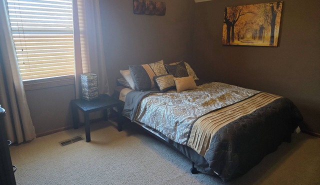 4-bedroom house in Olathe w/fitness equipment and finished basement.