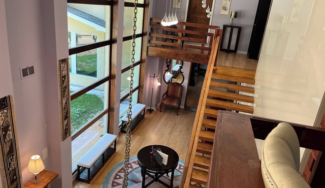 5-Bedroom 6000SF wood and glass retreat in Atlanta, surrounded by greenery.