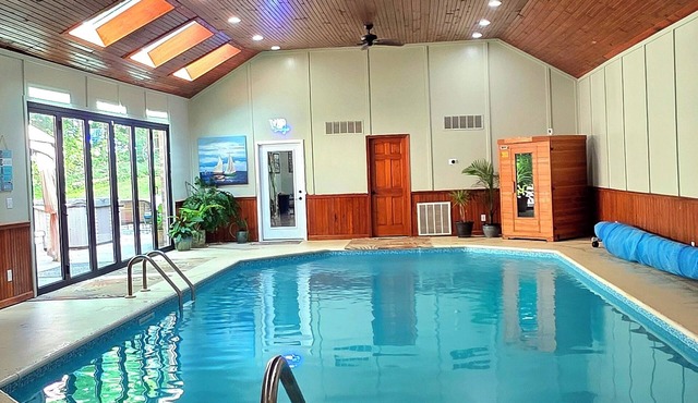 5 BR, Indoor heated pool, hot tub, sauna, game room, bar, & theatre room.