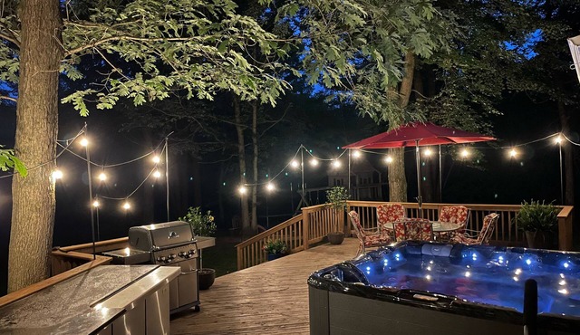 A beautiful recently remodeled home nested on a wooded river lot with a hot tub.