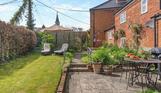 A beautifully curated cottage sleeping four with two sleek bathrooms.